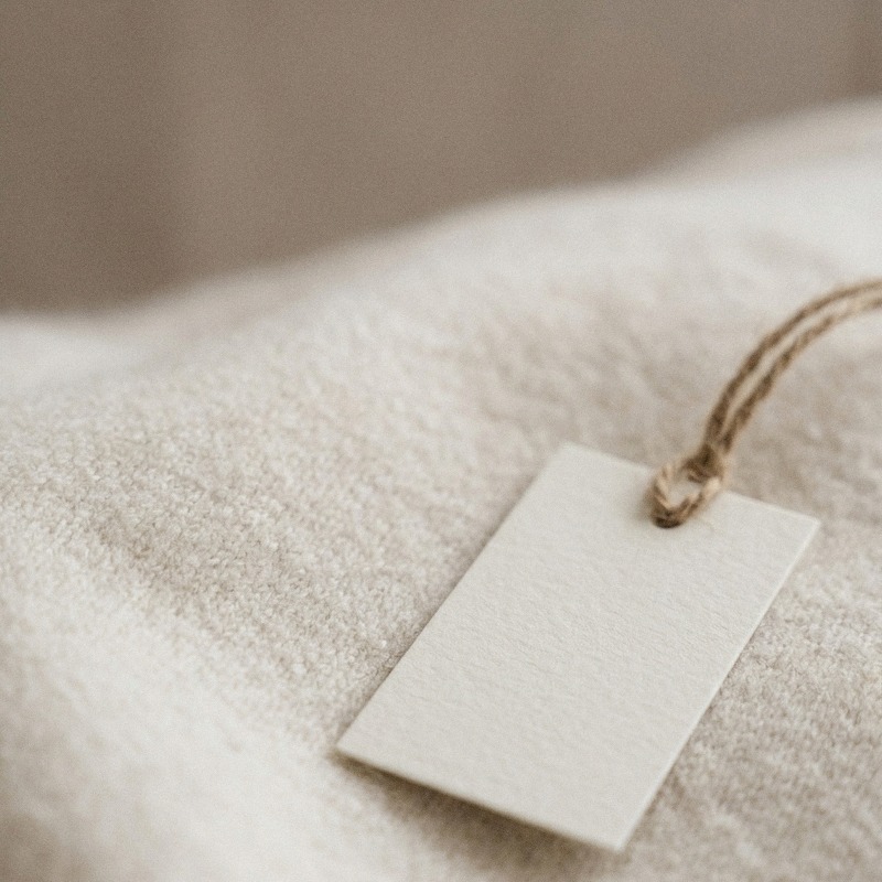 Certification tag resting on woven fabric